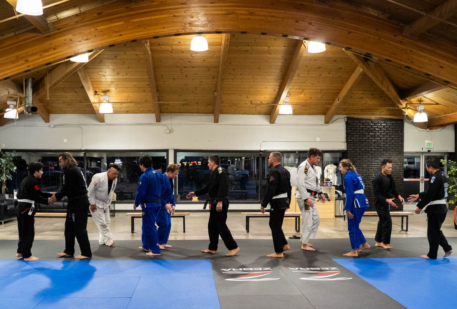 Claudio Franco BJJ class in gi greeting each other in a line